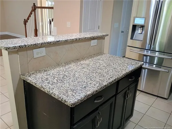 a kitchen with a sink counter top space and stainless steel appliances