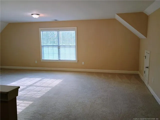 an empty room with a empty space and a window