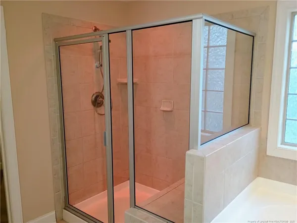 a bathroom with a glass shower door