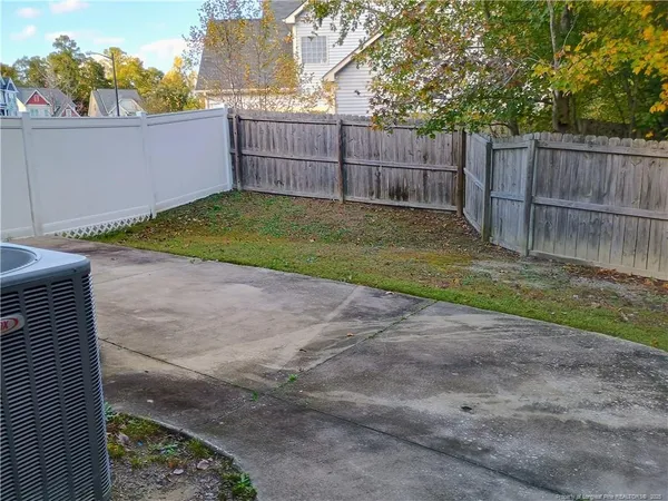a view of a backyard with a fence