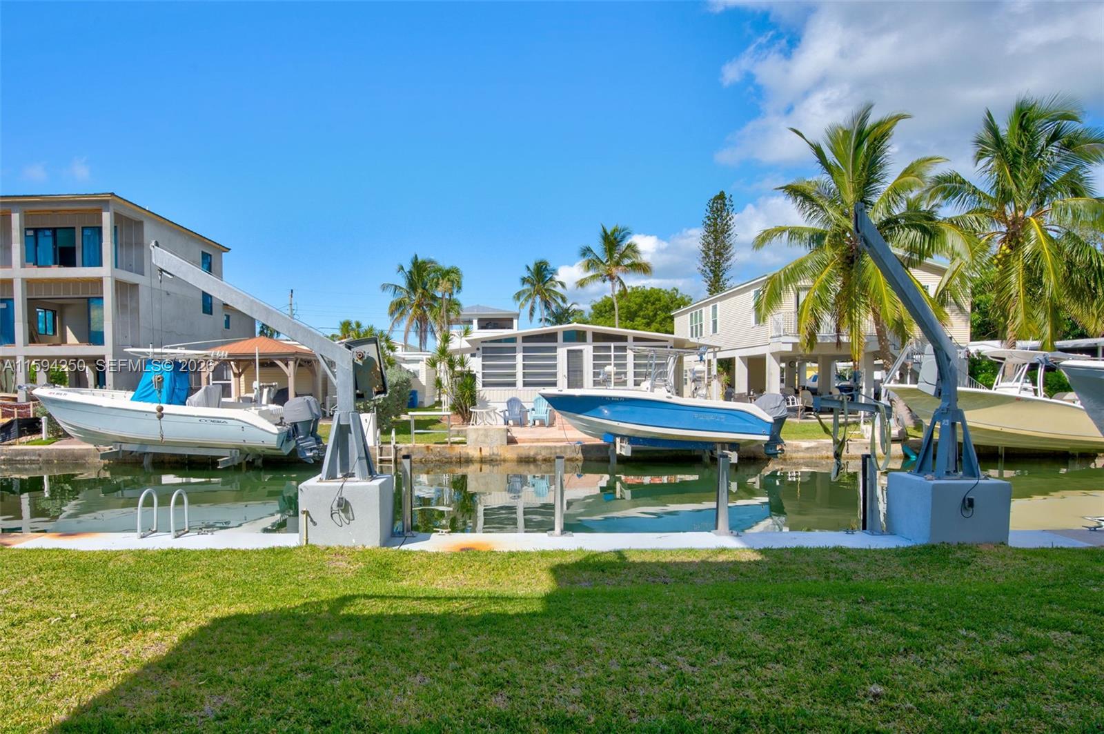 84 Coral Way Key Largo, FL 33037 - Photo 38 of 55 a front view of house with outdoor seating and yard