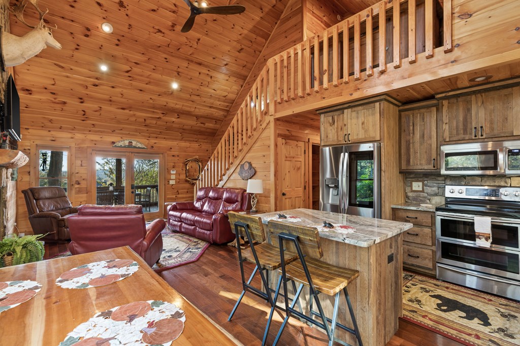 653 The Woods Road Mineral Bluff, GA 30559 - Photo 15 of 56 a view of an outside dining space with furniture