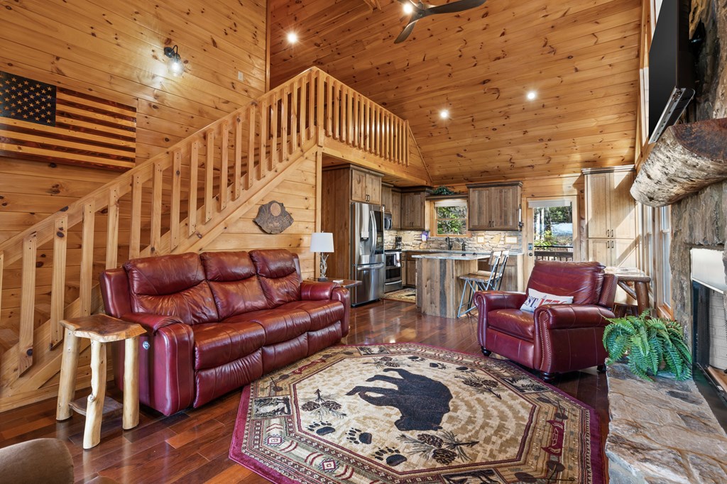 653 The Woods Road Mineral Bluff, GA 30559 - Photo 19 of 56 a living room with furniture and a fireplace