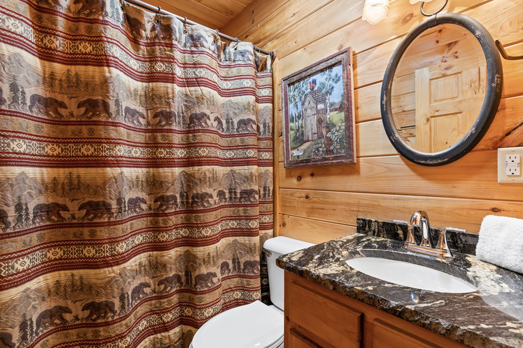 653 The Woods Road Mineral Bluff, GA 30559 - Photo 21 of 56 a bathroom with a granite countertop double vanity and a mirror
