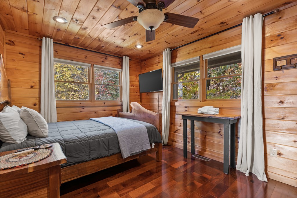 653 The Woods Road Mineral Bluff, GA 30559 - Photo 26 of 56 a bedroom with a bed and wooden floor