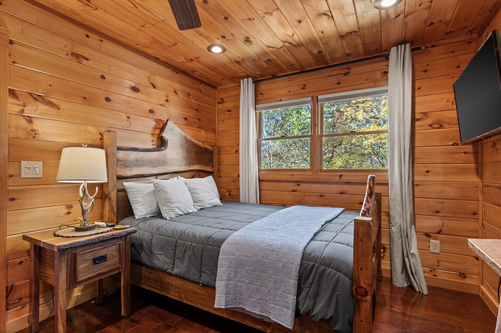653 The Woods Road Mineral Bluff, GA 30559 - Photo 27 of 56 a bed sitting in a bedroom next to a window