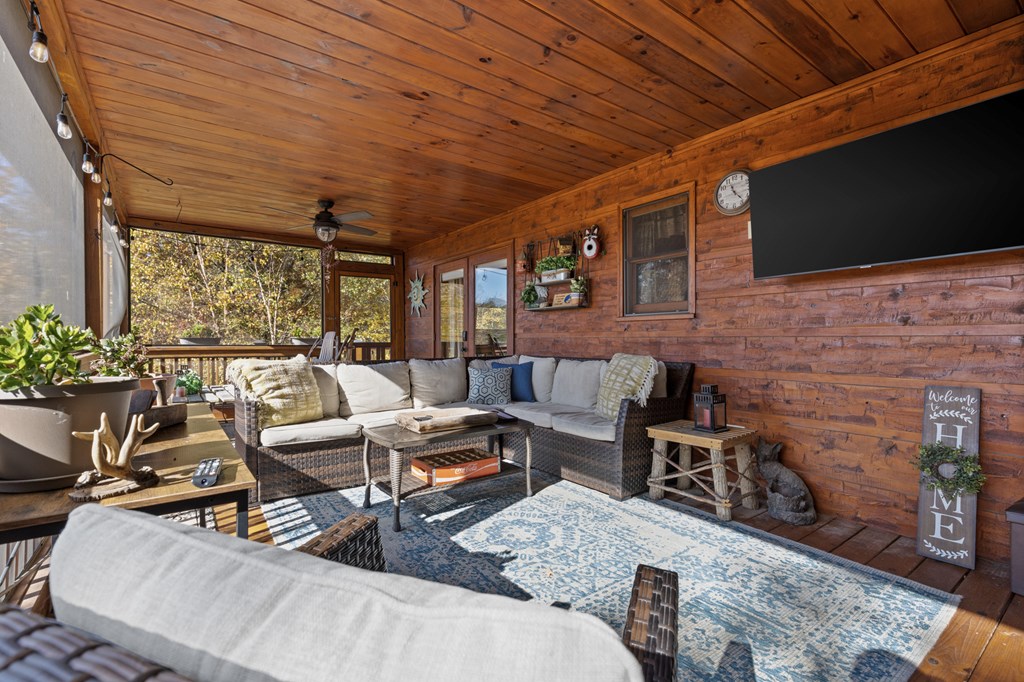 653 The Woods Road Mineral Bluff, GA 30559 - Photo 32 of 56 a outdoor living space with patio furniture and a flat screen tv