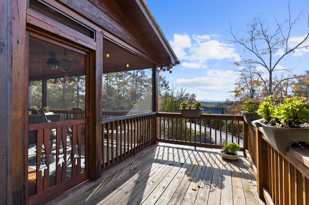 653 The Woods Road Mineral Bluff, GA 30559 - Photo 35 of 56 a view of balcony with wooden floor and outdoor seating