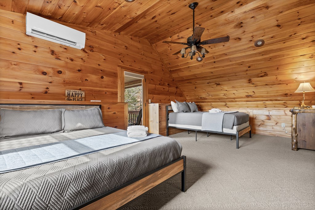 653 The Woods Road Mineral Bluff, GA 30559 - Photo 42 of 56 a bedroom with a bed and wooden floor