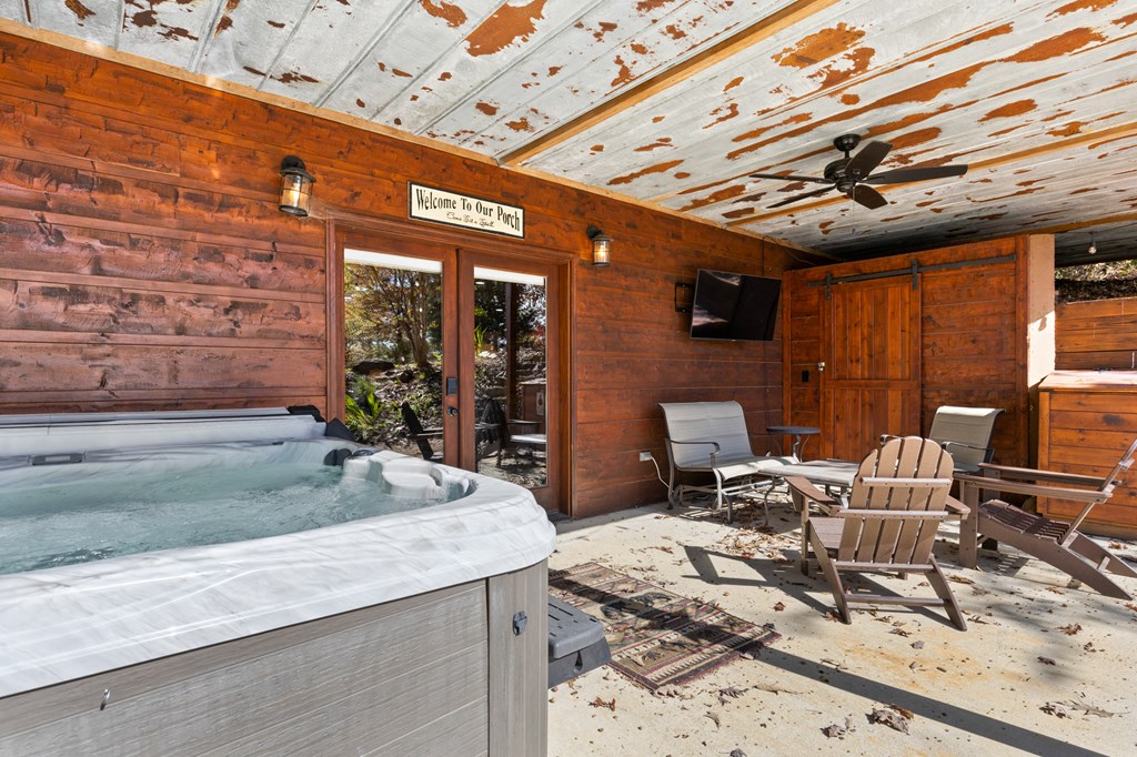 653 The Woods Road Mineral Bluff, GA 30559 - Photo 54 of 56 a view of a patio with table and chairs with wooden floor