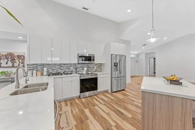 a living room with furniture a flat screen tv and a large window