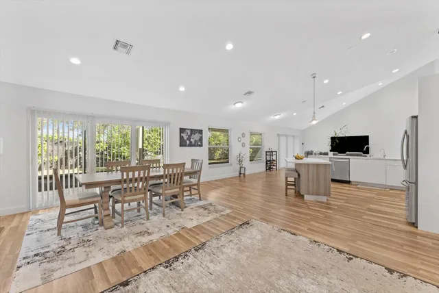 a large white kitchen with a table and chairs