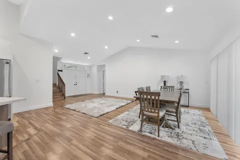a bathroom with a granite countertop sink a toilet and bathtub