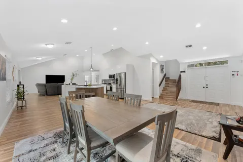 a view of a workspace with furniture and wooden floor