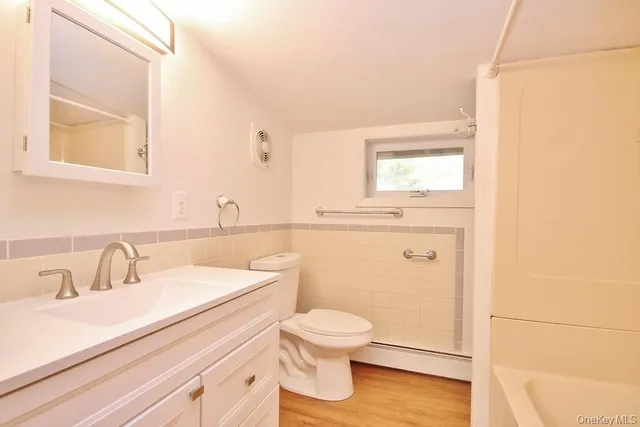 a bathroom with a toilet a sink and a mirror