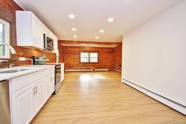 a view of a kitchen with a sink and cabinets