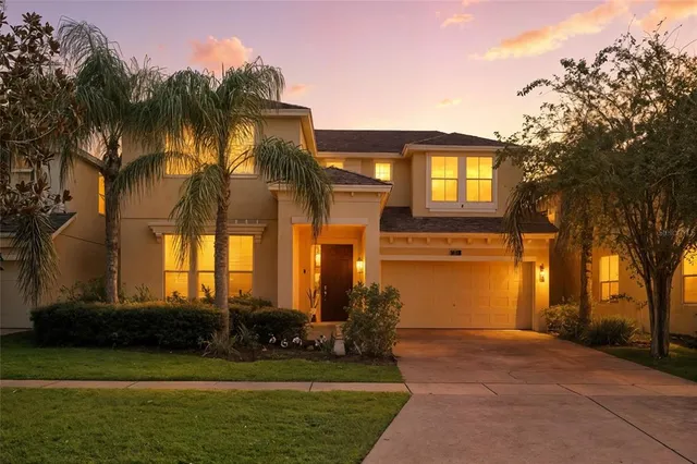 a front view of a house with a yard and a garage