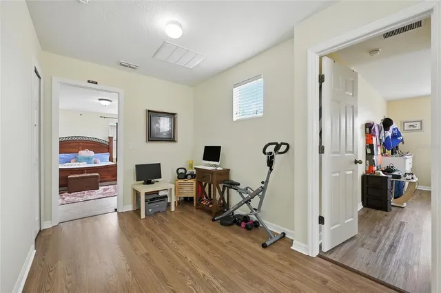 a bedroom with a bed and wooden floor