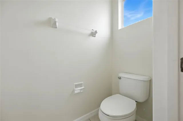 a bedroom with two beds and a large window