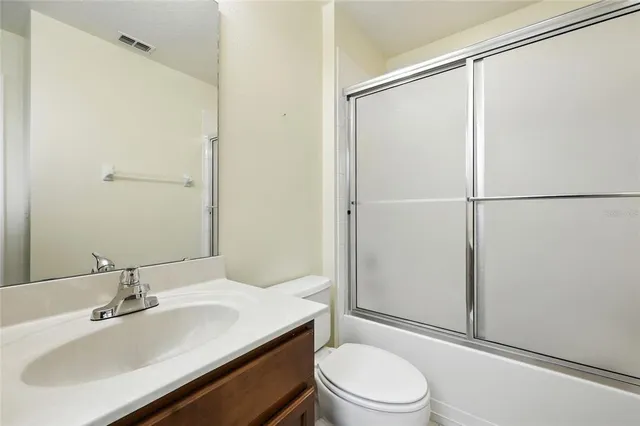 a spacious bedroom with a bed and a wooden floor