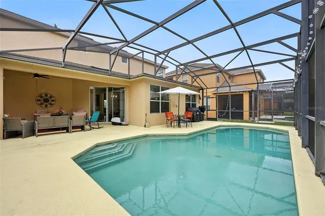 a view of a house with a big yard and large trees