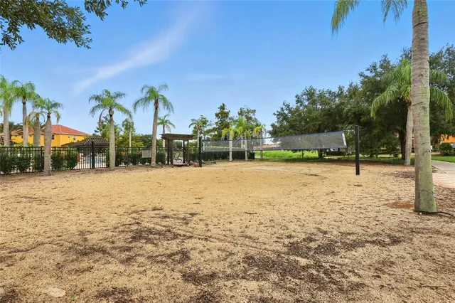 a living room with fireplace furniture and floor to ceiling windows