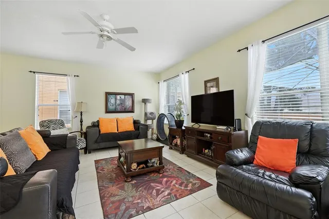 a living room with furniture kitchen and a chandelier