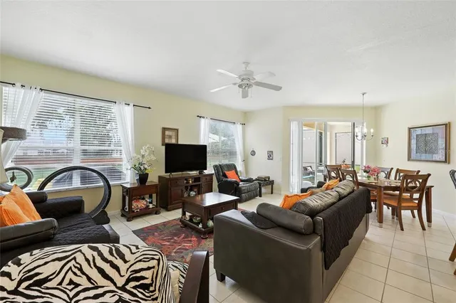 a living room with furniture and a view of kitchen