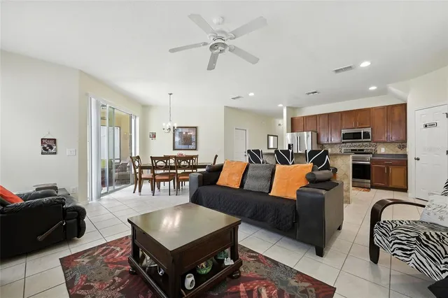 a kitchen with stainless steel appliances a stove a sink a microwave a refrigerator and cabinets