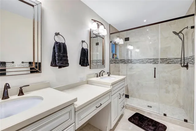 a bathroom with double vanity sink and a mirror