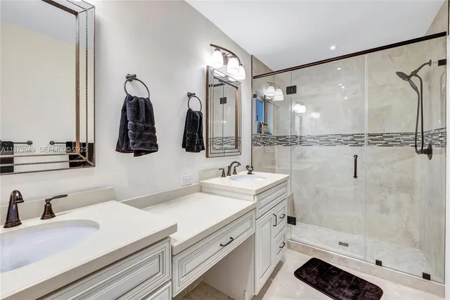 a bathroom with double vanity sink and a mirror