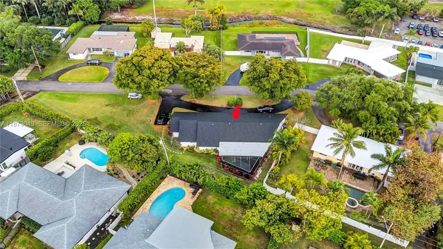 an aerial view of a house with a yard pool patio and outdoor seating