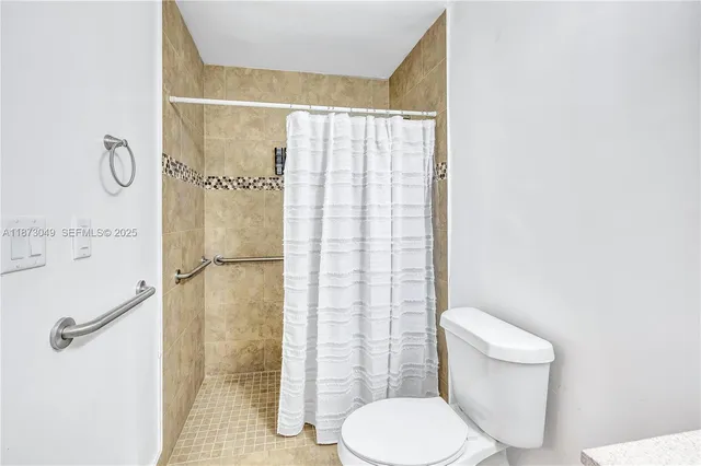 a white toilet sitting next to a bathroom sink