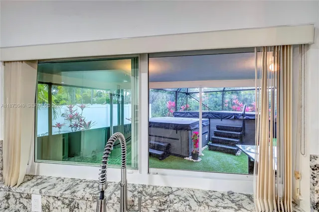 a living room filled with furniture and a large window