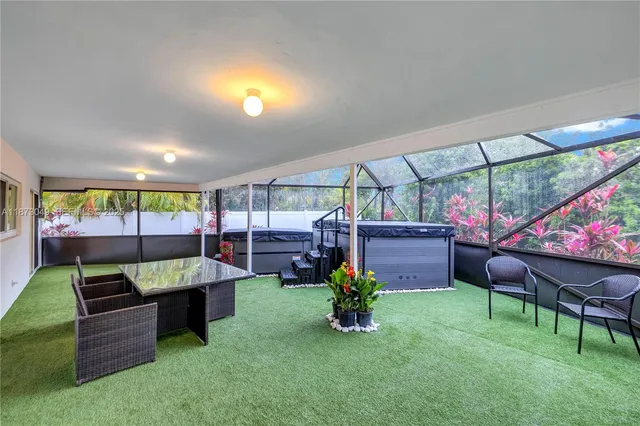 a living room with furniture and a floor to ceiling window