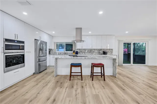 a kitchen with a sink cabinets and stainless steel appliances