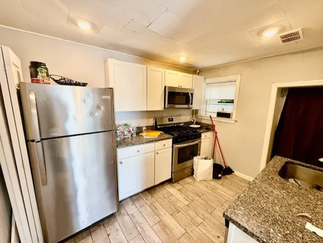 a kitchen with a refrigerator a stove top oven a sink and dishwasher