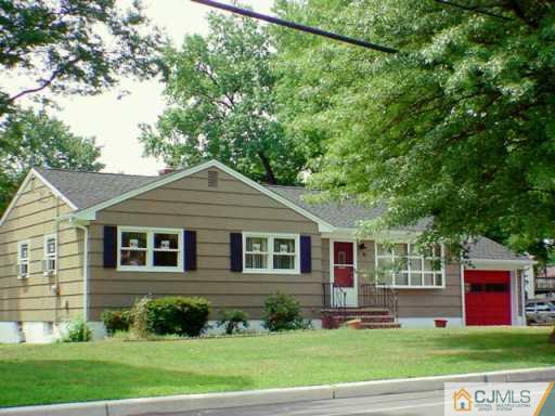 833 Inman Avenue Edison, NJ 08820 - Photo 2 of 8 a front view of a house with a yard and trees