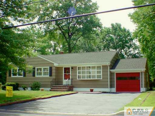 833 Inman Avenue Edison, NJ 08820 - Photo 3 of 8 a front view of a house with a yard and garage