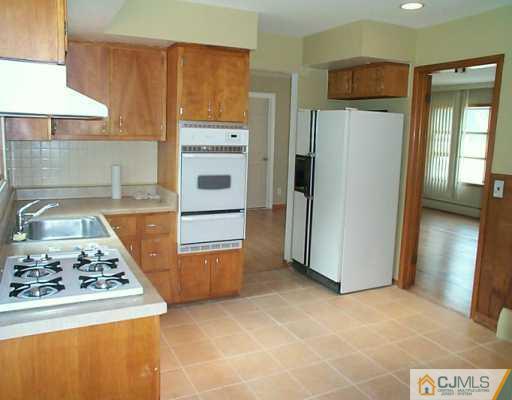 833 Inman Avenue Edison, NJ 08820 - Photo 4 of 8 a kitchen with refrigerator and stove
