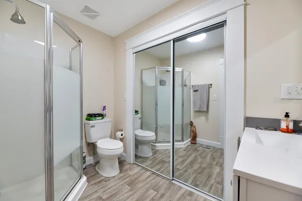 a bathroom with a sink toilet and shower