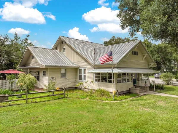 a view of a house with a yard patio and slide