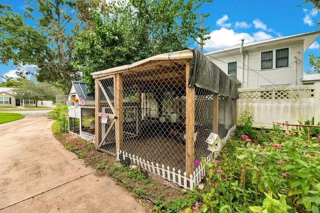 an aerial view of a house with a yard and garden