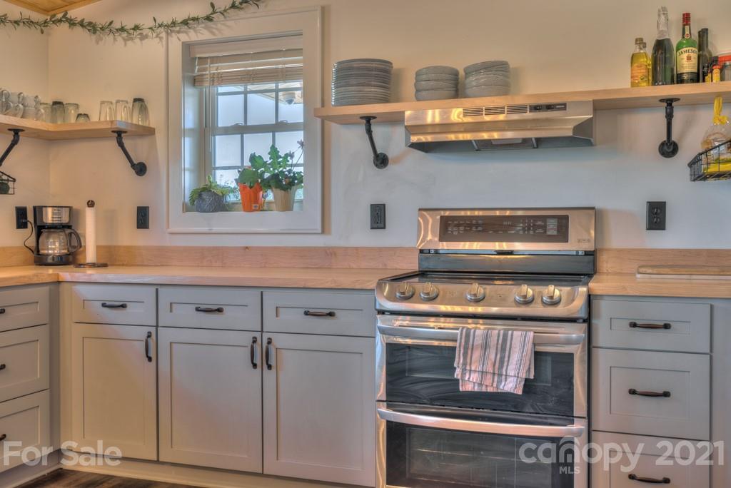 2380 New House Road Ellenboro, NC 28040 - Photo 40 of 44 a kitchen with cabinets and a stove
