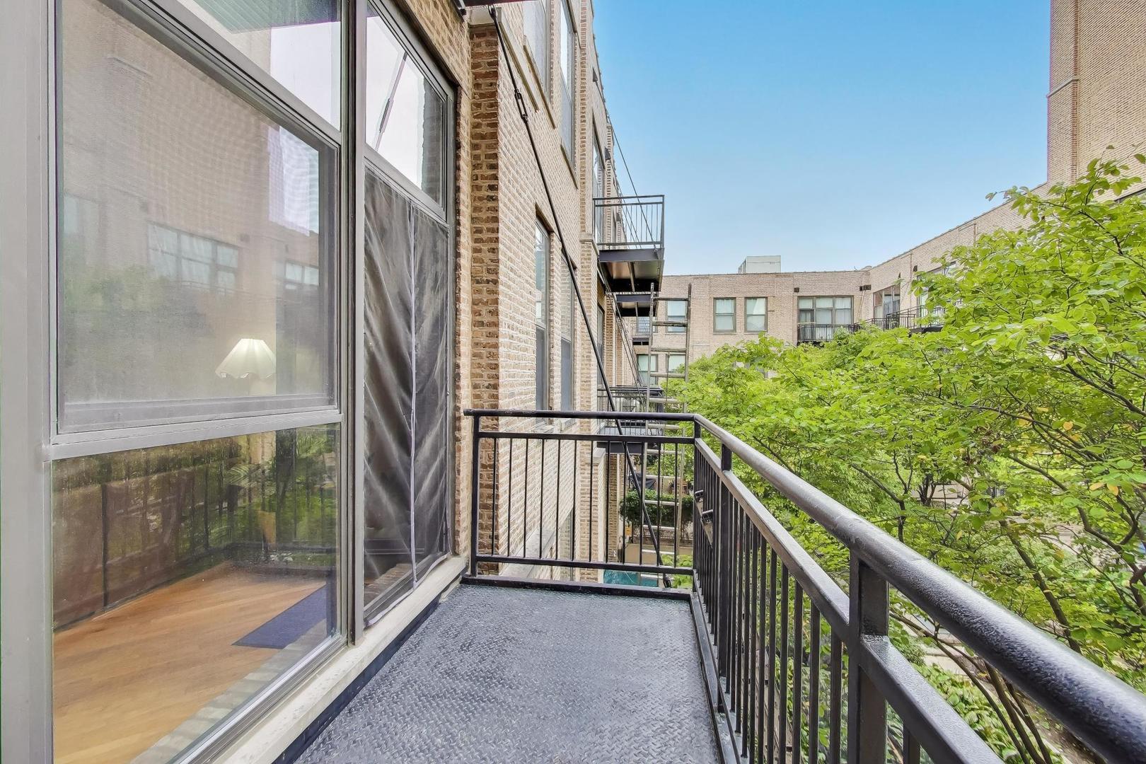 1040 West Adams Street, Unit 370 Chicago, IL 60607 - Photo 16 of 27 a view of balcony with a floor to ceiling window and stairs