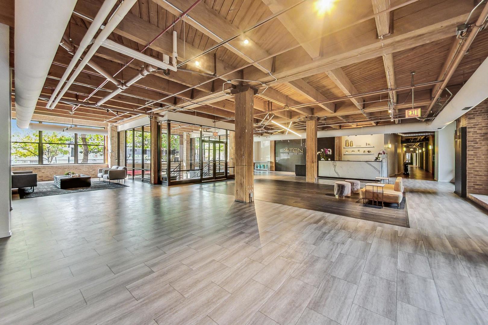 1040 West Adams Street, Unit 370 Chicago, IL 60607 - Photo 17 of 27 a view of a hall with wooden floors