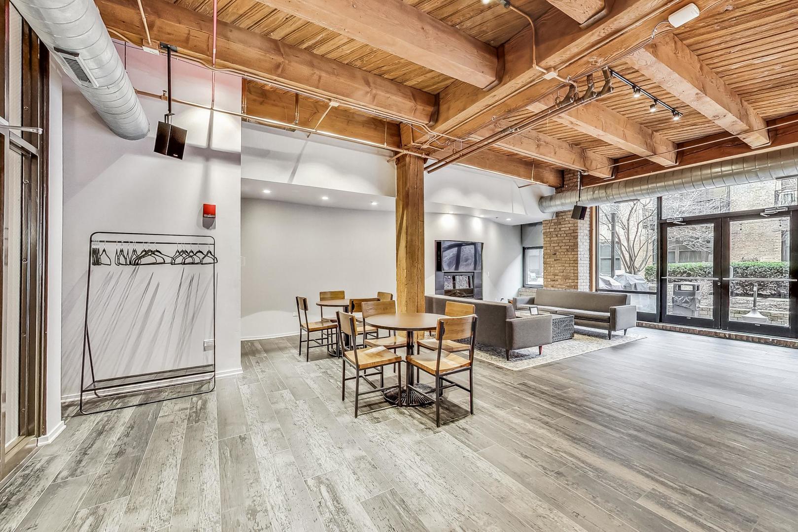1040 West Adams Street, Unit 370 Chicago, IL 60607 - Photo 22 of 27 a dining room with furniture and wooden floor