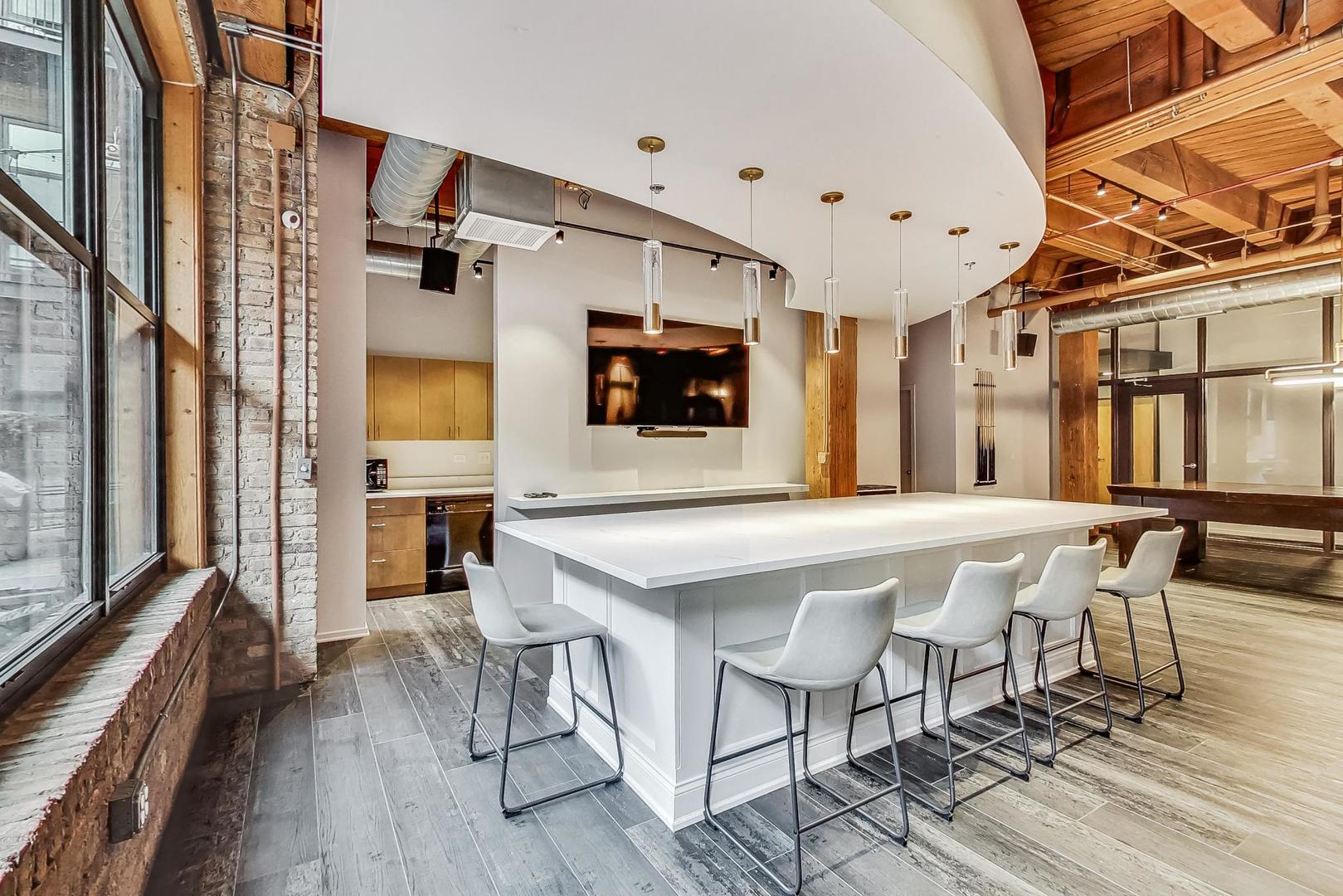 1040 West Adams Street, Unit 370 Chicago, IL 60607 - Photo 24 of 27 a front view of a house with a table and chairs