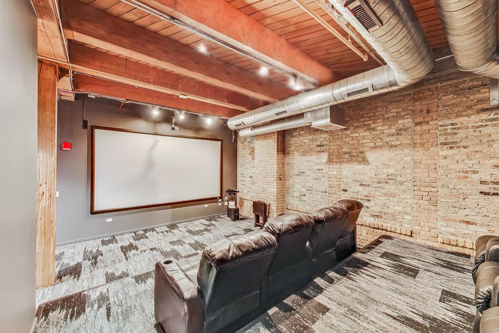 1040 West Adams Street, Unit 370 Chicago, IL 60607 - Photo 27 of 27 a bed sitting in a bedroom next to a mirror