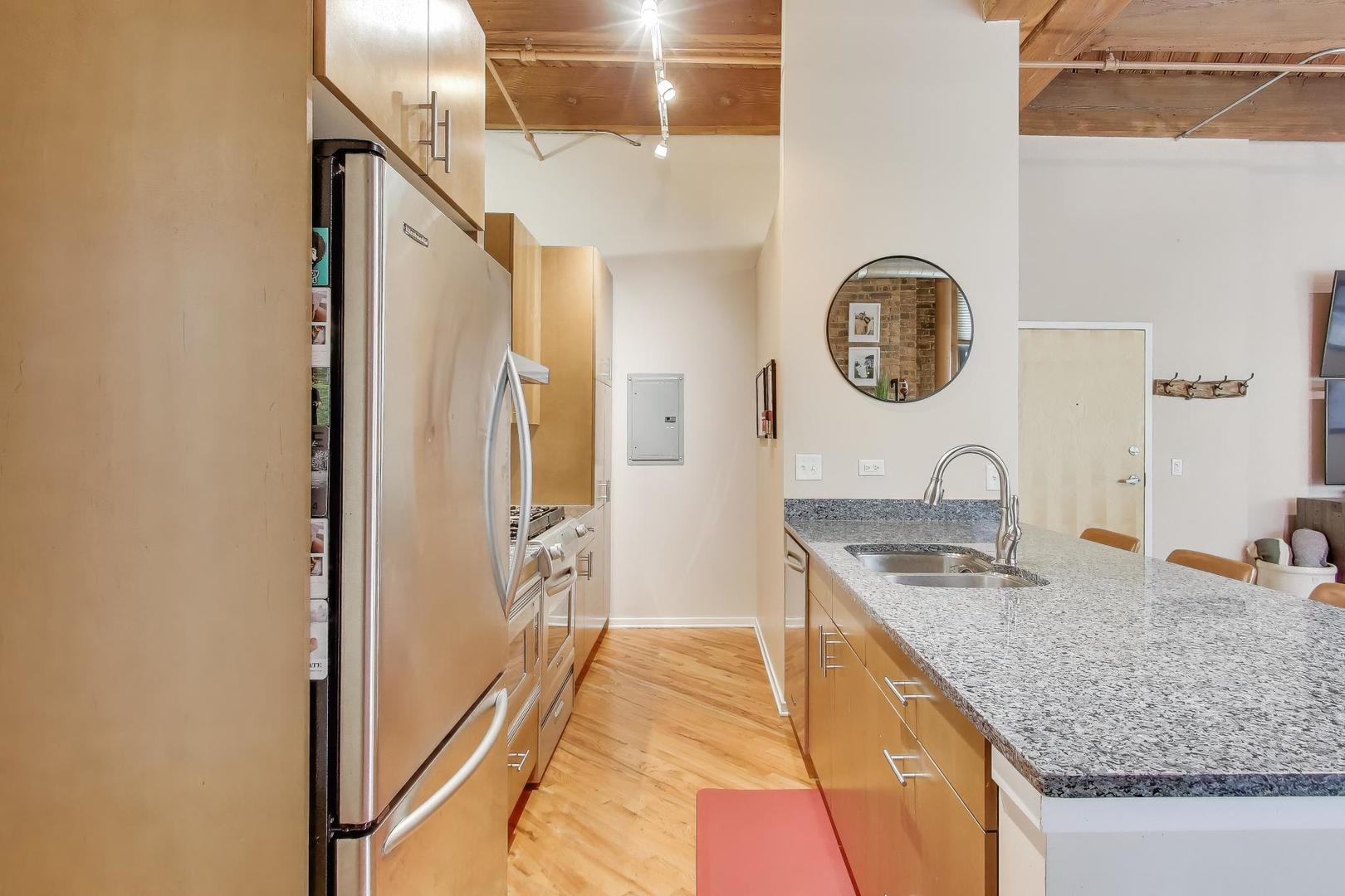 1040 West Adams Street, Unit 370 Chicago, IL 60607 - Photo 6 of 27 a bathroom with a granite countertop sink and a mirror